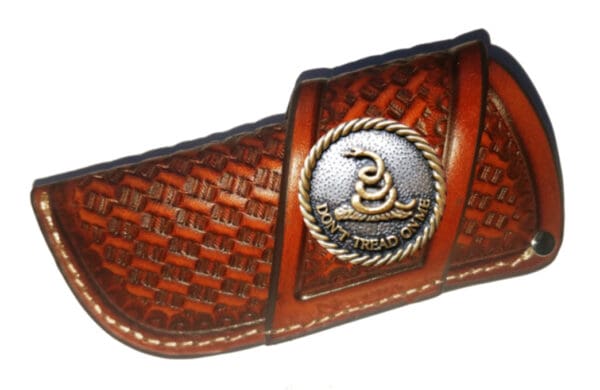 Leather knife sheath with "Don't Tread On Me" emblem.